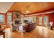 Cozy living room with hardwood floors, a stone fireplace, and expansive windows offering natural light at 95 Blueberry Rdg, Pittsboro, NC 27312