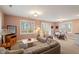 Cozy living space with neutral tones, a plush sofa, and views to the exterior deck at 95 Blueberry Rdg, Pittsboro, NC 27312