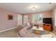 Inviting living room with warm neutral color palette and views from two windows at 95 Blueberry Rdg, Pittsboro, NC 27312