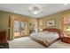 Spacious main bedroom with a ceiling fan, ensuite bathroom, and a private deck overlooking a beautiful backyard at 95 Blueberry Rdg, Pittsboro, NC 27312