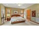 Comfortable main bedroom featuring a neutral color scheme, bedside tables, and serene view from the windows at 95 Blueberry Rdg, Pittsboro, NC 27312