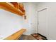 Mudroom featuring tile floors, coat hooks, shelf and bench next to entrance door at 95 Blueberry Rdg, Pittsboro, NC 27312