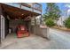 Under deck storage area with tractor, gravel driveway and block retaining wall at 95 Blueberry Rdg, Pittsboro, NC 27312