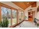 Bright sunroom with wood ceiling, tile floors and large windows overlooking the wooded yard at 95 Blueberry Rdg, Pittsboro, NC 27312