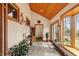 Bright sunroom with tile floors, wooden ceiling and large windows overlooking the wooded yard at 95 Blueberry Rdg, Pittsboro, NC 27312