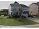 Charming two-story home with a well-maintained lawn, landscaped garden beds and a two car garage at 1001 Hope Springs Ln, Morrisville, NC 27560