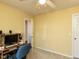 Functional bedroom with a ceiling fan, desk, and adjacent bathroom at 101 Tiverton Woods Dr, Holly Springs, NC 27540