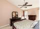 Comfortable bedroom with a ceiling fan, and dark wood furniture at 101 Tiverton Woods Dr, Holly Springs, NC 27540