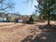 A single-story brick home with a well-manicured lawn and beautiful surroundings at 101 Tiverton Woods Dr, Holly Springs, NC 27540