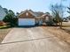 Inviting single-story brick home featuring an attached garage and a long driveway at 101 Tiverton Woods Dr, Holly Springs, NC 27540