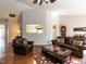 Spacious living room with hardwood floors, a vaulted ceiling, and comfortable leather furniture at 101 Tiverton Woods Dr, Holly Springs, NC 27540