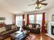 Spacious living room with hardwood floors, a fireplace, and sliding glass doors at 101 Tiverton Woods Dr, Holly Springs, NC 27540