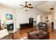 Comfortable living room featuring hardwood floors, a fireplace, and ample seating at 101 Tiverton Woods Dr, Holly Springs, NC 27540
