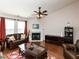 A cozy living room featuring a fireplace, hardwood floors, and ample natural light at 101 Tiverton Woods Dr, Holly Springs, NC 27540