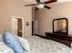 Bedroom featuring a ceiling fan, furniture, and an open door to an ensuite bathroom at 101 Tiverton Woods Dr, Holly Springs, NC 27540
