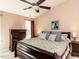 The cozy main bedroom is furnished with dark wood furniture and has soft, neutral walls at 101 Tiverton Woods Dr, Holly Springs, NC 27540