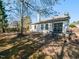 A spacious patio area is ideal for outdoor dining and entertaining with a swing, and garden at 101 Tiverton Woods Dr, Holly Springs, NC 27540