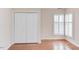 Bedroom with wood floors, white shutters, and closet at 103 Kirkwood Dr., Chapel Hill, NC 27514