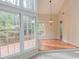 Bright dining room with views of nature, wooden floors and hanging chandelier at 103 Kirkwood Dr., Chapel Hill, NC 27514