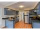 Traditional kitchen featuring stainless steel appliances and blue cabinets at 103 Kirkwood Dr., Chapel Hill, NC 27514