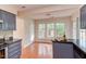 Kitchen with wood floors and breakfast bar area with large windows at 103 Kirkwood Dr., Chapel Hill, NC 27514