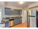 Traditional kitchen featuring stainless steel appliances and blue cabinets at 103 Kirkwood Dr., Chapel Hill, NC 27514