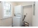 Efficient laundry area featuring a stacked washer and dryer and convenient storage shelves at 103 Kirkwood Dr., Chapel Hill, NC 27514