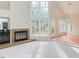 Bright living room featuring fireplace, large windows, and wood floors at 103 Kirkwood Dr., Chapel Hill, NC 27514