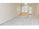 Sitting room area with carpet and bright light with door to outside at 103 Kirkwood Dr., Chapel Hill, NC 27514