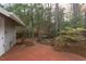 A brick patio that creates a serene outdoor living space that extends into a wooded backyard at 103 Kirkwood Dr., Chapel Hill, NC 27514