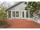 A brick patio offers seamless transitions to the indoors with multiple windows and access points at 103 Kirkwood Dr., Chapel Hill, NC 27514