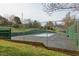 Community tennis court featuring a well-maintained surface and a secure chain-link fence, ready for recreational enjoyment at 103 Kirkwood Dr., Chapel Hill, NC 27514