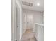 A view of a hallway with neutral paint, carpet floors, and access to a laundry room at 103 Shelfit Trl, Oxford, NC 27565