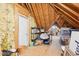 Unfinished attic space with exposed beams and a door to a storage area at 104 Barnes Spring Ct, Cary, NC 27519