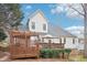 Charming backyard with a deck, wooden pergola, and a well-manicured lawn at 104 Barnes Spring Ct, Cary, NC 27519