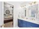 Bathroom with double sink vanity, gold hardware and lighting, and tiled shower at 104 Barnes Spring Ct, Cary, NC 27519