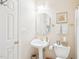 Powder room featuring pedestal sink, framed mirror, and light colored walls at 104 Barnes Spring Ct, Cary, NC 27519