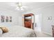 Cozy bedroom featuring wood TV cabinet, ceiling fan and adjoining bathroom at 104 Barnes Spring Ct, Cary, NC 27519