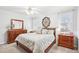 Bright bedroom featuring wood furnishings, ceiling fan, and light colored walls at 104 Barnes Spring Ct, Cary, NC 27519