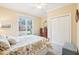 Bedroom featuring large window, wood chest, double closet doors, and carpeted floor at 104 Barnes Spring Ct, Cary, NC 27519