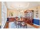 Elegant dining room with hardwood floors, a chandelier, and classic wooden furniture at 104 Barnes Spring Ct, Cary, NC 27519