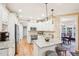 Bright kitchen with granite countertops, stainless steel appliances, and white cabinetry at 104 Barnes Spring Ct, Cary, NC 27519