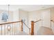 Landing featuring banister with wood railing and pendant light at 104 Barnes Spring Ct, Cary, NC 27519