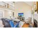 Bright living room with a fireplace, cathedral ceiling, hardwood floors, and comfortable seating at 104 Barnes Spring Ct, Cary, NC 27519