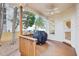 Covered patio with a wooden railing and a ceiling fan, providing a shaded space for relaxing at 104 Barnes Spring Ct, Cary, NC 27519