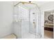 Modern shower featuring marble tiling and glass block window at 104 Barnes Spring Ct, Cary, NC 27519