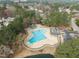 Aerial view showcasing a pristine community pool with lounge areas and well-maintained grounds at 105 Aberson Ct, Cary, NC 27519