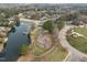 Aerial view showing a community playground and pond with fountain and a bridge to gazebo at 105 Aberson Ct, Cary, NC 27519