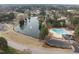 Beautiful aerial view of community amenities including a pond with fountain and swimming pool with parking at 105 Aberson Ct, Cary, NC 27519