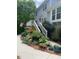 Charming backyard showing a deck, stairs, and a landscaped walkway surrounded by lush plantings at 105 Aberson Ct, Cary, NC 27519